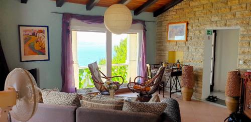 a living room with a couch and a large window at Villa Mihael in Celina