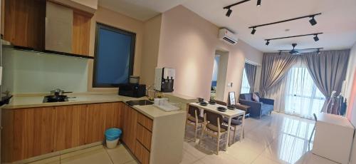 a kitchen with a sink and a table with chairs at Sunway Geo Suites at Bandar Sunway by Ezprop-CA0F in Subang Jaya