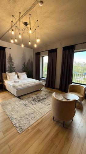 a bedroom with a bed and a table and chairs at Отель Авеню in Oral