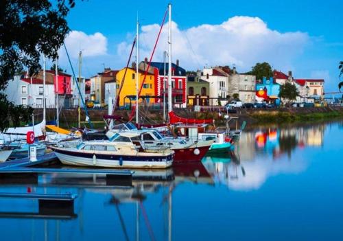 a group of boats are docked in a harbor at Location Meublée 8 Personnes - Proche Trentemoult in Rezé
