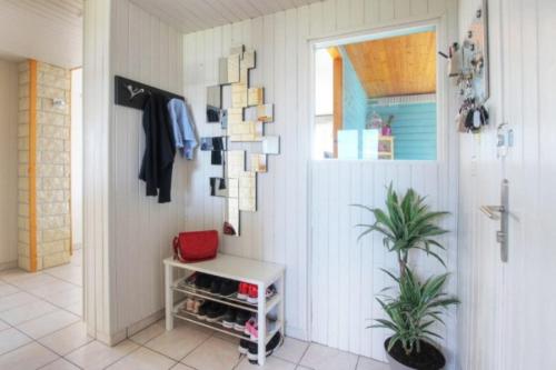 a room with a closet with a table and a plant at Location Meublée 8 Personnes - Proche Trentemoult in Rezé