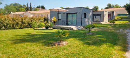 Saint-Germain-de-LusignanLes Logis de la Seugne的带花园的房屋，院子里有棕榈树