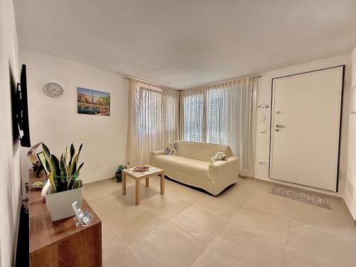 a living room with a couch and a table at Arsi House in Diano Castello