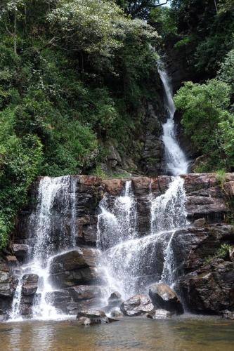 a waterfall on the side of a rocky river at Summerfield in Kandy