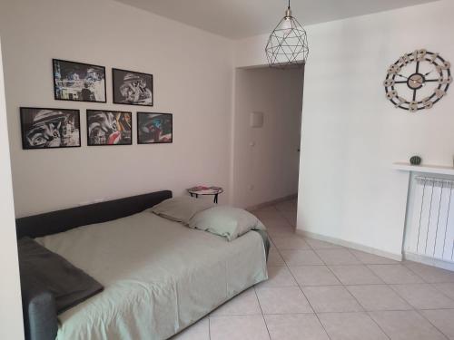 a bedroom with a bed and pictures on the wall at Casa André in Imola