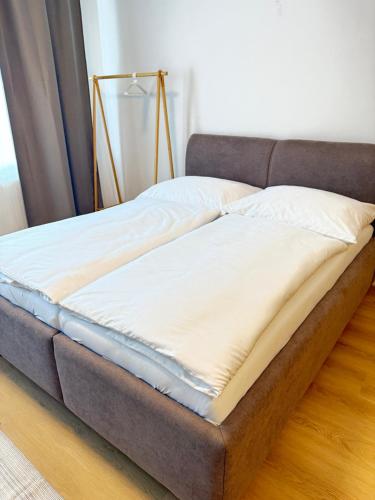 a bed sitting on top of a wooden floor at Riverside Apartment Praha in Prague