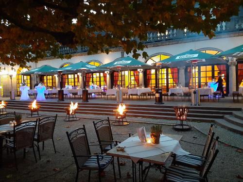 a group of tables and chairs with lights in front of a building at Dolce by Wyndham Bad Nauheim in Bad Nauheim