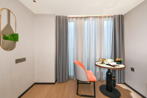 a room with a table and a chair and a window at Atour X Hotel West Nanjing Road in Shanghai