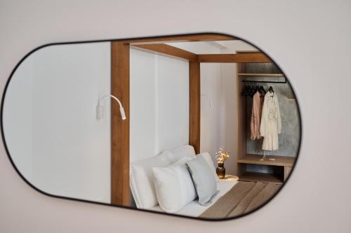 a mirror reflection of a white chair in a dressing room at Kyamon Luxury Villa - Peaceful Escape with Heated Pool near Chania! in Chania Town