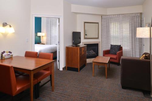 a living room with a room with a bed and a television at Residence Inn Columbia Northeast/Fort Jackson Area in Columbia