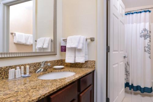 a bathroom with a sink and a mirror at Residence Inn Columbia Northeast/Fort Jackson Area in Columbia