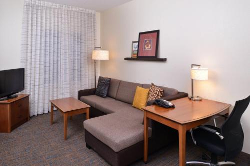 a living room with a couch and a table at Residence Inn Columbia Northeast/Fort Jackson Area in Columbia