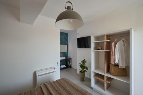 a bedroom with a closet and a lamp at Kyamon Luxury Villa - Peaceful Escape with Heated Pool near Chania! in Chania Town