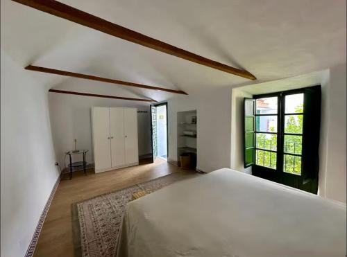 a bedroom with a white bed and a window at Espectacular Casa Cordobesa in Córdoba