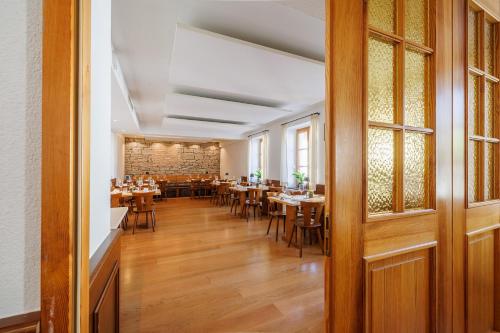 a dining room with wooden tables and chairs at Gasthaus Adler Konstanz in Konstanz