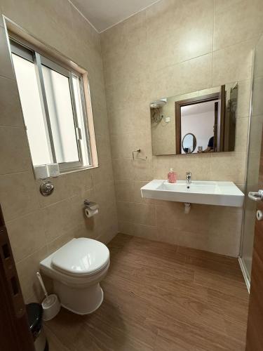 a bathroom with a toilet and a sink at Slimiza Suites in Sliema