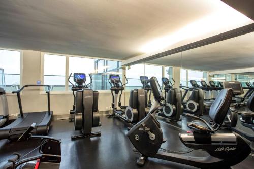 a gym with several treadmills and elliptical machines at The Wade in Chicago