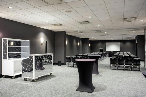 a conference room with tables and chairs and a screen at The Wade in Chicago