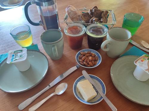 a table with plates of food and drinks and coffee at Sur la Draille in Le Vigan