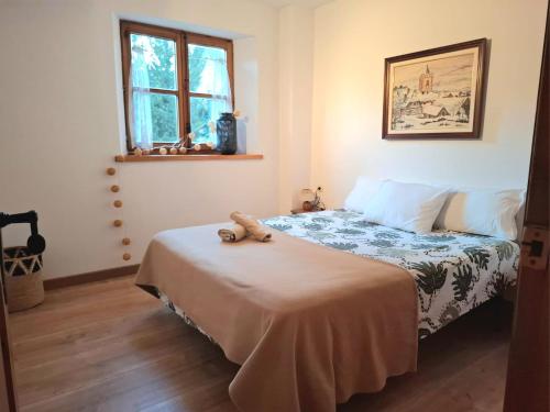 a bedroom with a bed with a stuffed animal on it at Isard Apartment in Pla de l'Ermita