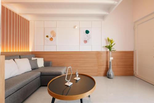 a living room with a couch and a table at Stavros Beachfront Suites in Nea Kydonia