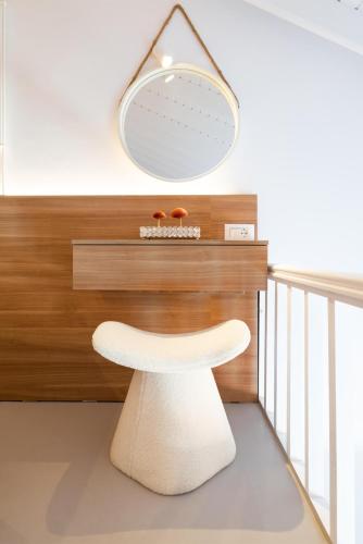 a white stool in a room with a mirror at Stavros Beachfront Suites in Nea Kydonia