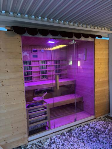 a purple room in a wooden house with purple lights at Bubble World Wild Love in Adelfia