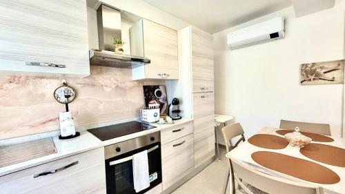 a small kitchen with a table and a counter at Arsi House in Diano Castello