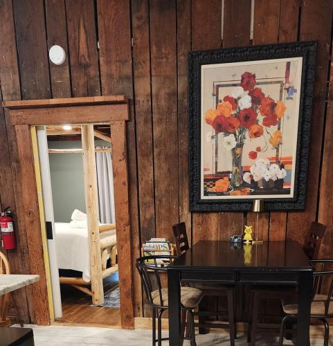 a dining room with a table and a vase of flowers at Red River Gorge Farmhouse 50 Acres in Stanton