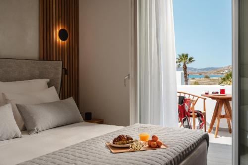 a hotel room with a tray of food on a bed at Phaistos Suites in Agios Prokopios