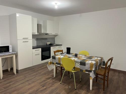 a kitchen and dining room with a table and chairs at La ferme 