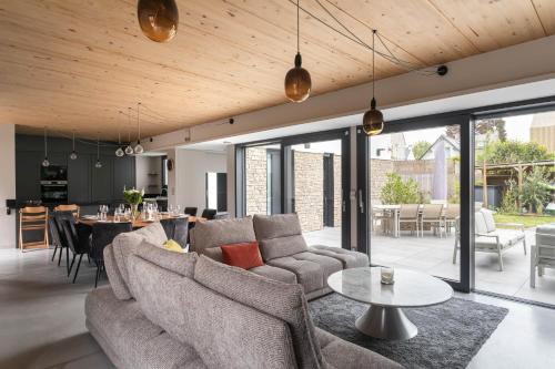 a living room with two couches and a table at Villa Ker Jade - vue sur la mer in Lancieux