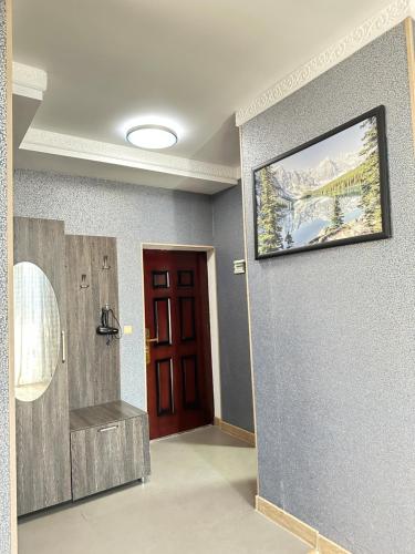 a room with a door and a painting on the wall at Apartament on Rustaveli in Batumi