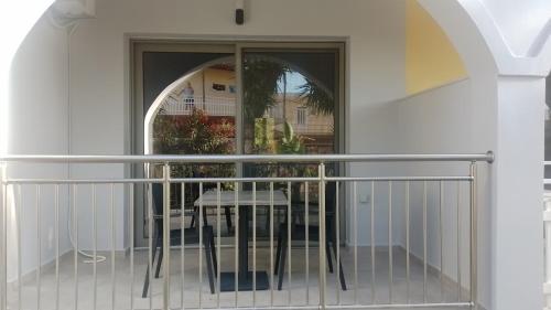 a balcony with a table and a window at EVDOKIAS Apt,brand new 2025 modern Apt in the center of Alikanas in Alikanas