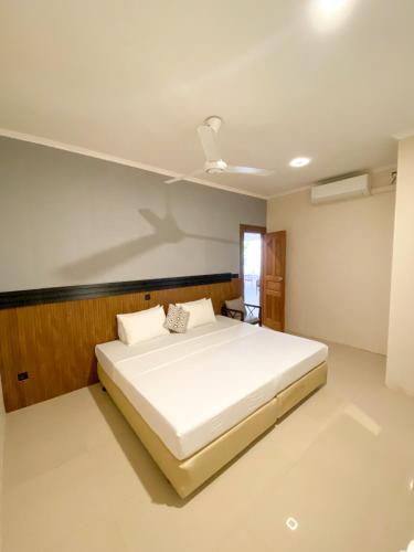 a bedroom with a large white bed in it at Tropika Beach Thulusdhoo in Thulusdhoo