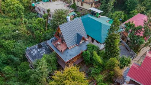 an overhead view of a house with a blue roof at SaffronStays The Divine Hima in Dharamshala