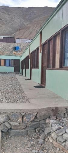 a building with a stone walkway in front of it at Pangong Destination in Spangmik