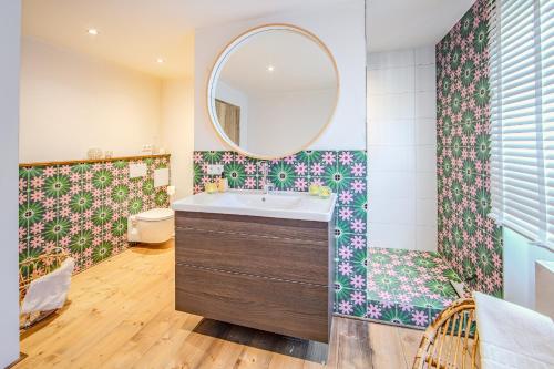 a bathroom with a sink and a mirror at Seeapartment Panorama in Gaienhofen