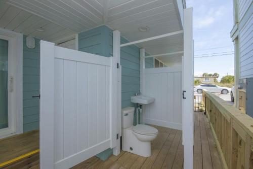 a bathroom with a toilet on a deck at Island Time- Wonderful Private Beachfront Home - Beautiful!!! in Panama City Beach