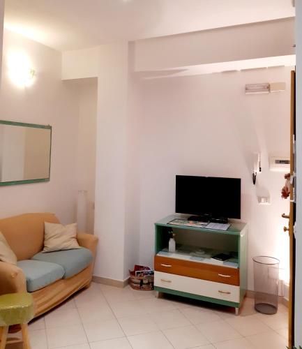 a living room with a couch and a flat screen tv at Casa Marcozzi Grottammare in Grottammare