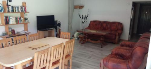 a living room with a couch and a table and chairs at Pod Orzechem in Sanok
