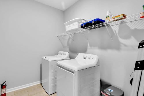 a kitchen with a white refrigerator and a sink at Charming 4BR Ranch-Style Home - Corner Lot home in Harvest
