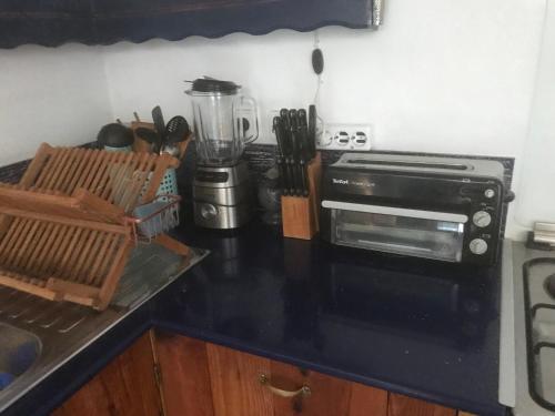 a kitchen with a black counter top with a blender at Clive and Bifi's house in Lachania