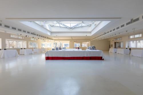 a large room with a table in the middle of it at Wall Art Hotel & Residence in Prato