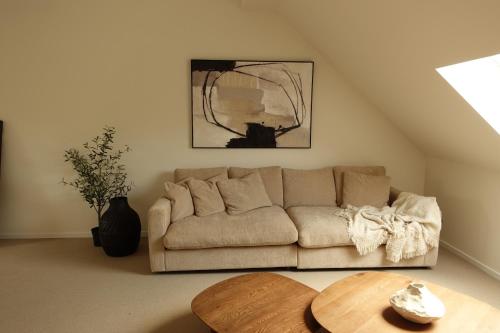 a living room with a couch and a table at La Barzalière in Chimay