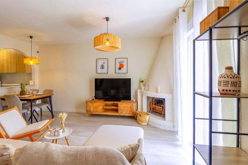 a living room with a couch and a tv at Espanatour SANTA ROSARIA in La Mata