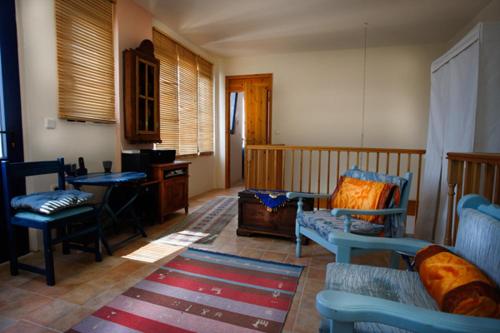 a living room with a couch and chairs and a table at Clive and Bifi's house in Lachania