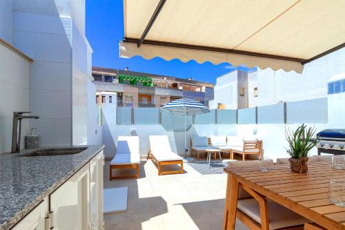 an outdoor patio with a wooden table and chairs at Espanatour SANTA ROSARIA in La Mata