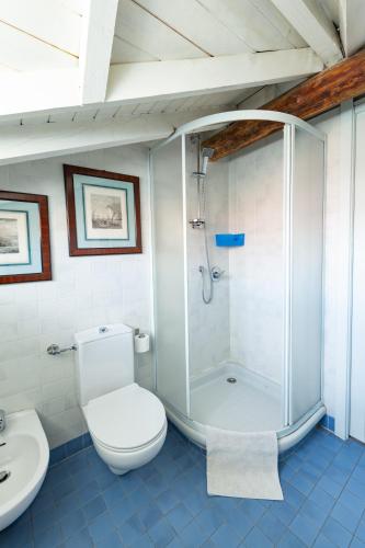 a bathroom with a shower and a toilet and a sink at Casa della Musica in Verbania