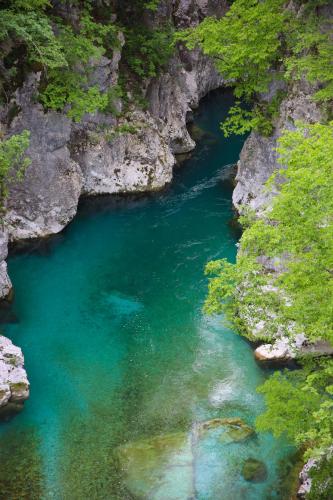 a river in a canyon with blue water at Plis Bujtina - Guesthouse in Kolgecaj